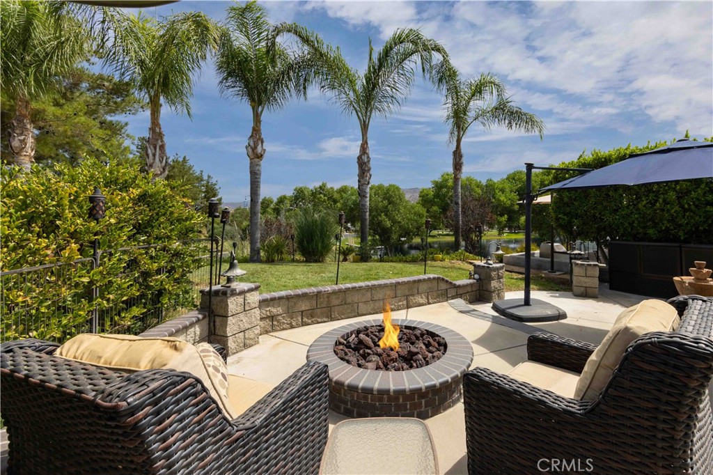 a view of a patio with couches potted plants and a swimming pool