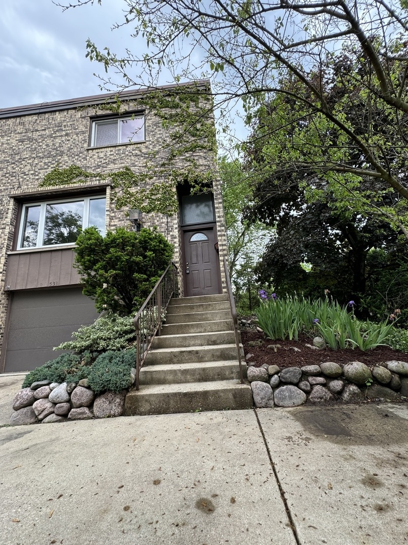 a front view of a house with a garden