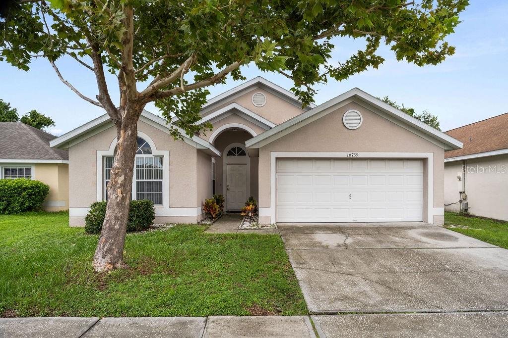 a front view of a house with a yard and garage