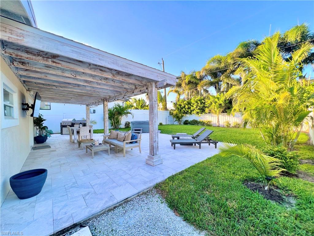 a view of a patio with table and chairs potted plants with wooden floor