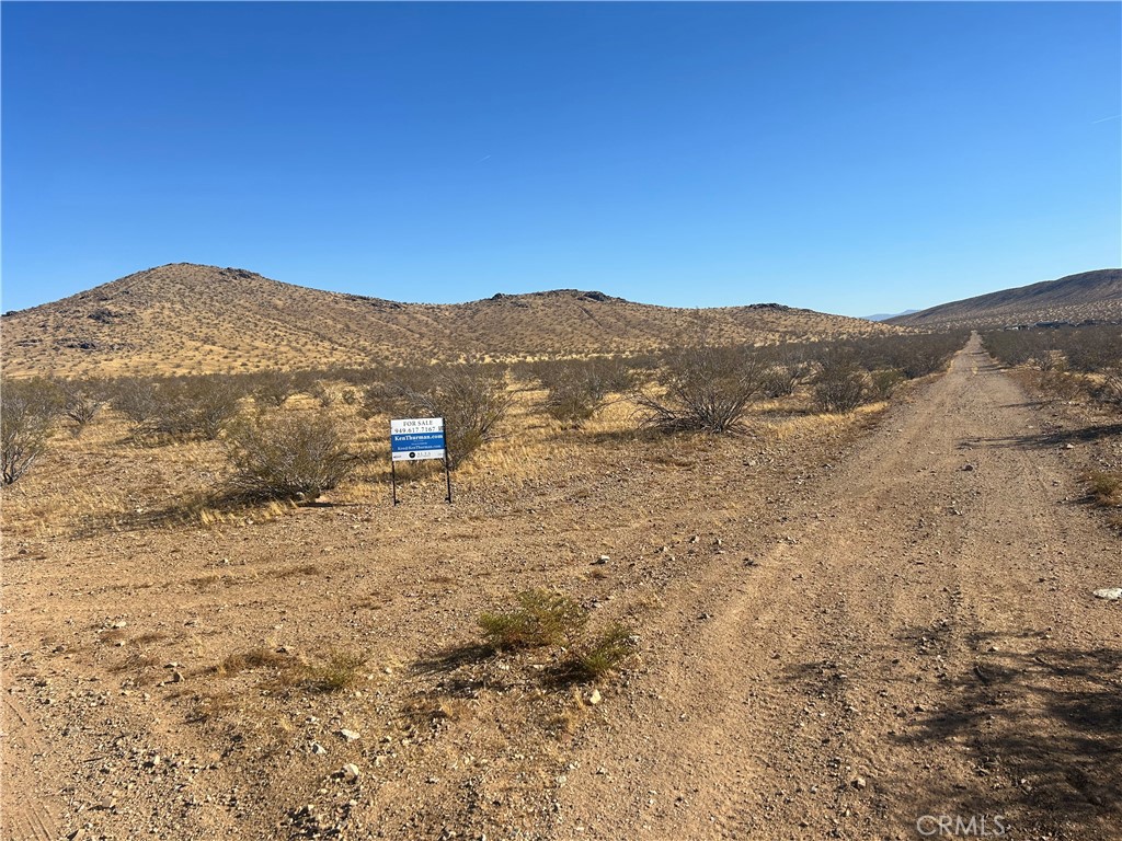 a view of a large mountain with mountains in the background