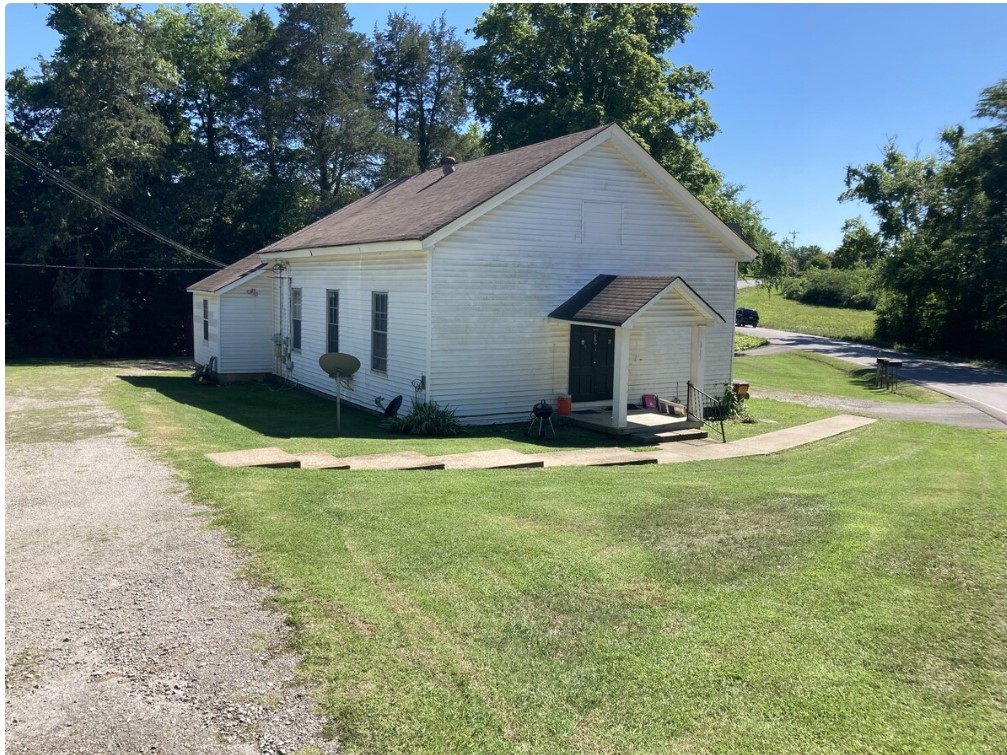 a view of a house with yard and a garden