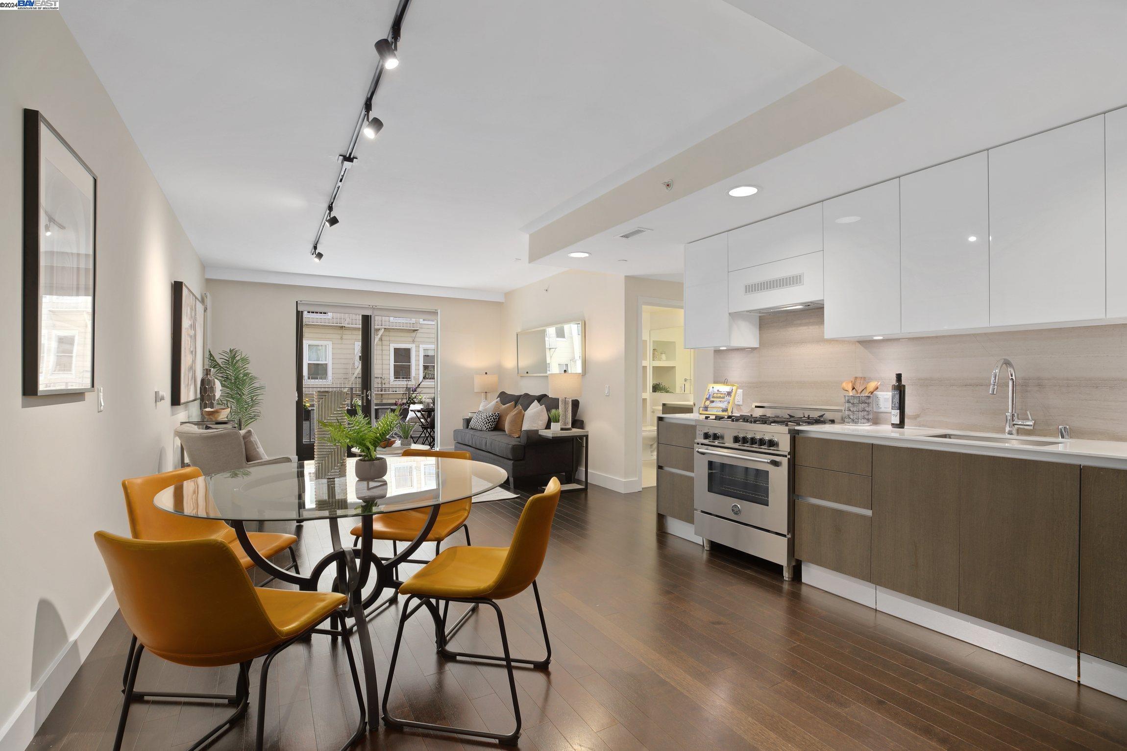 a kitchen with a dining table chairs and white cabinets