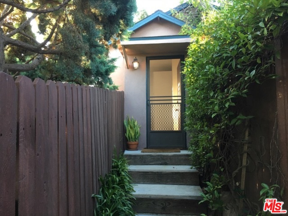 a view of house with garden space and trees