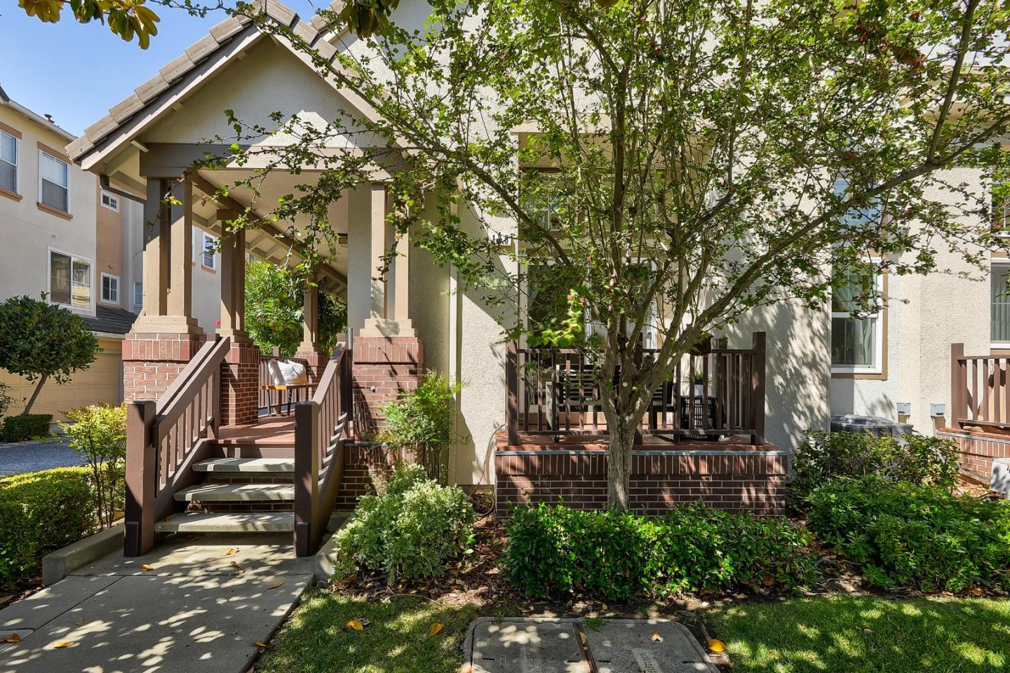 a view of a house with a tree in front