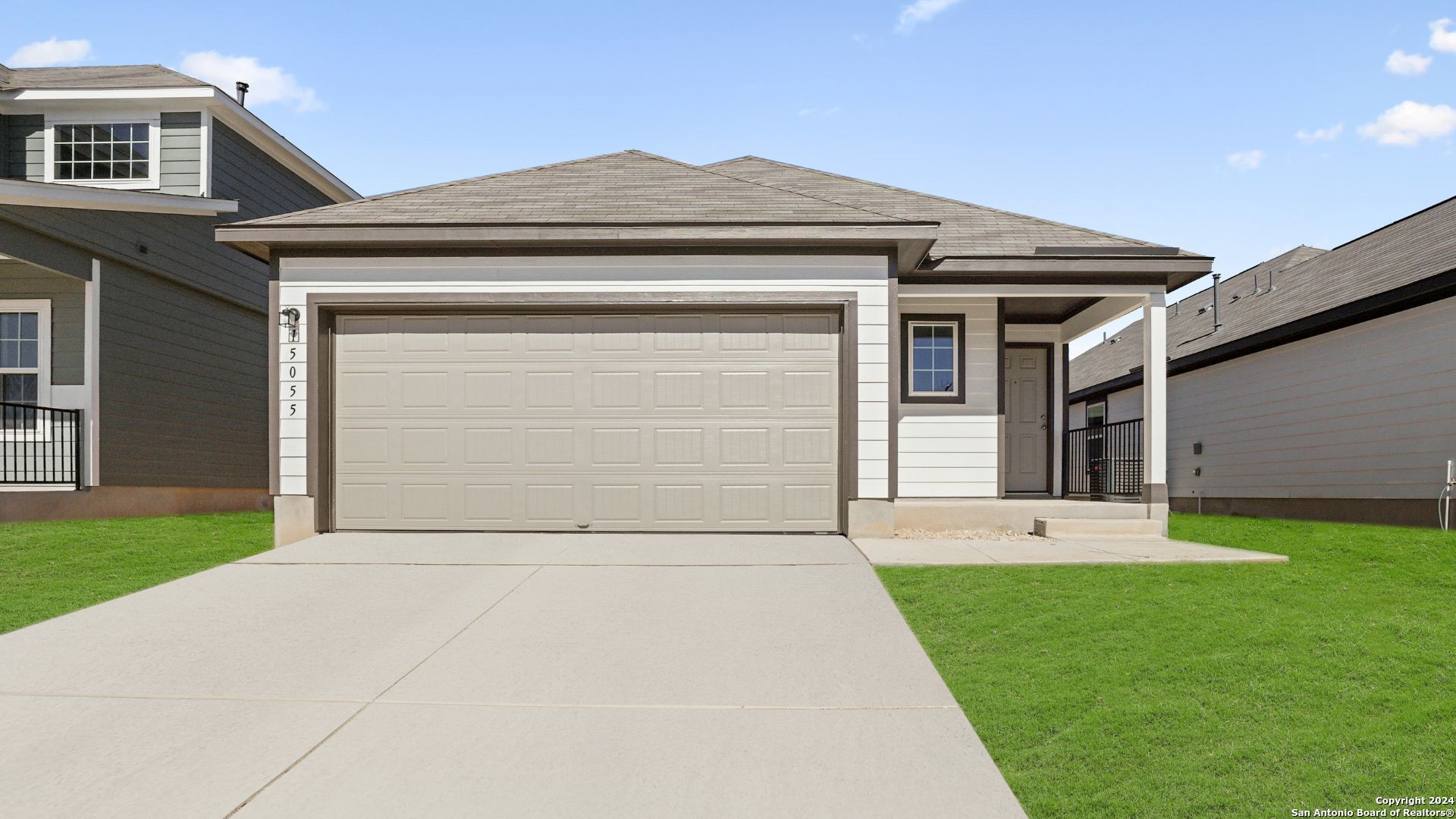 a front view of a house with a yard and garage