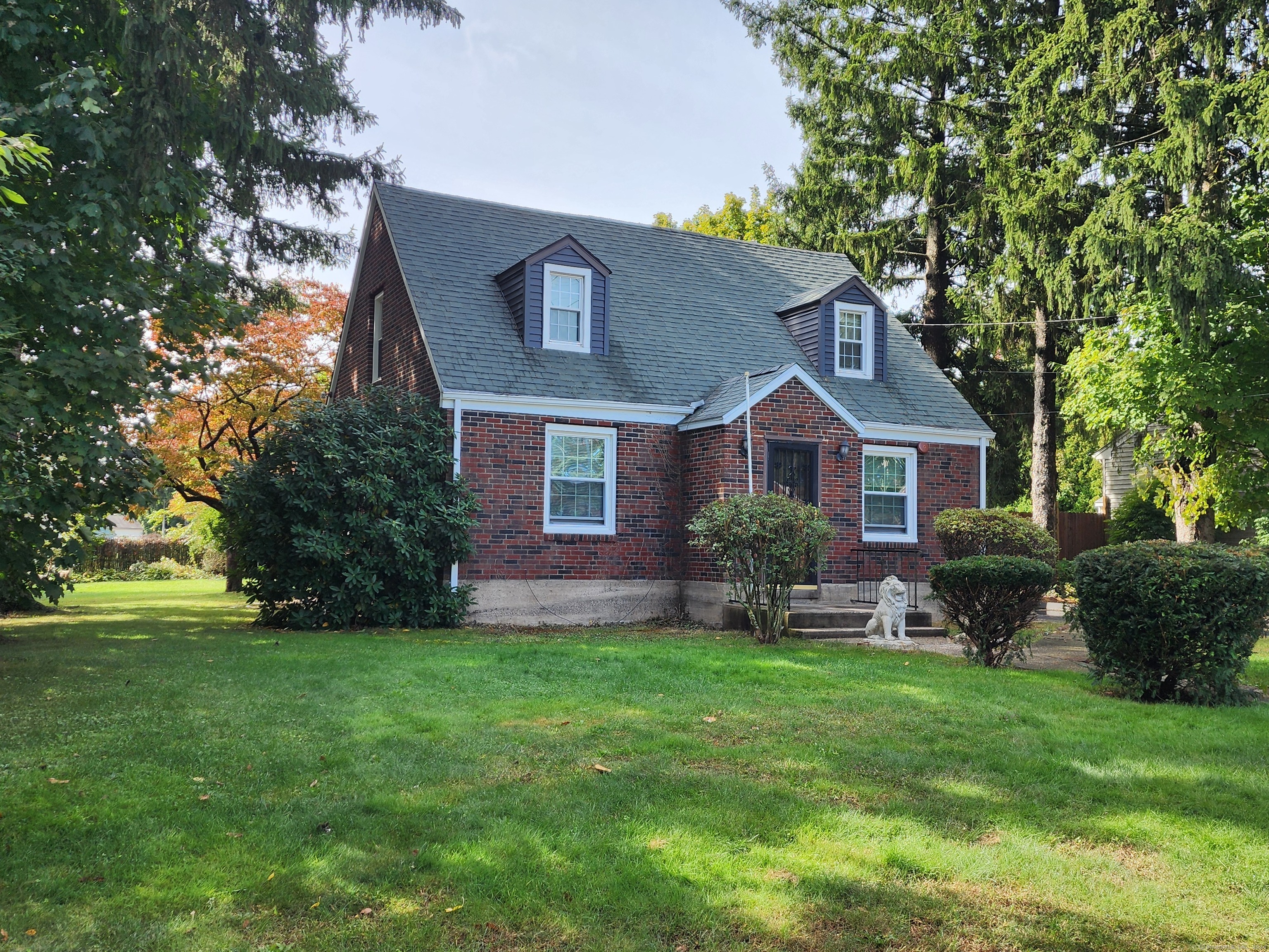 a front view of house with yard and green space