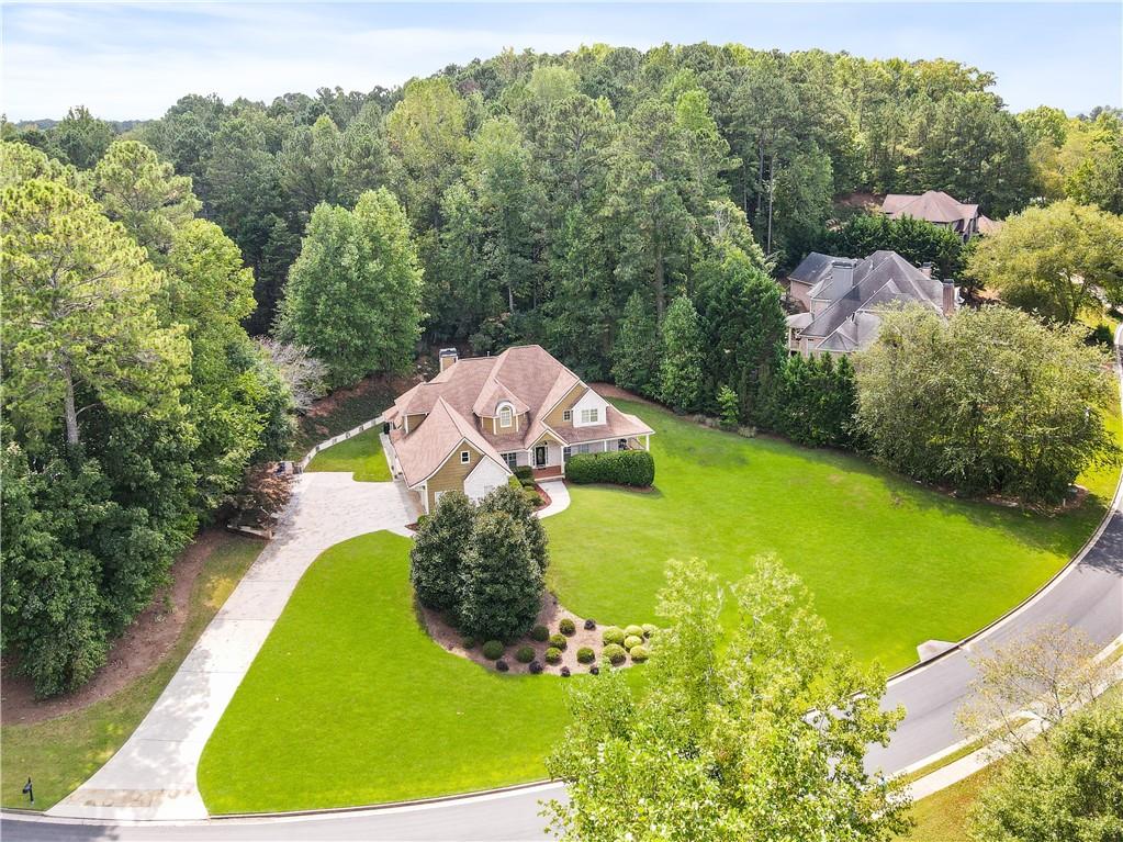 an aerial view of a house with a garden and swimming pool