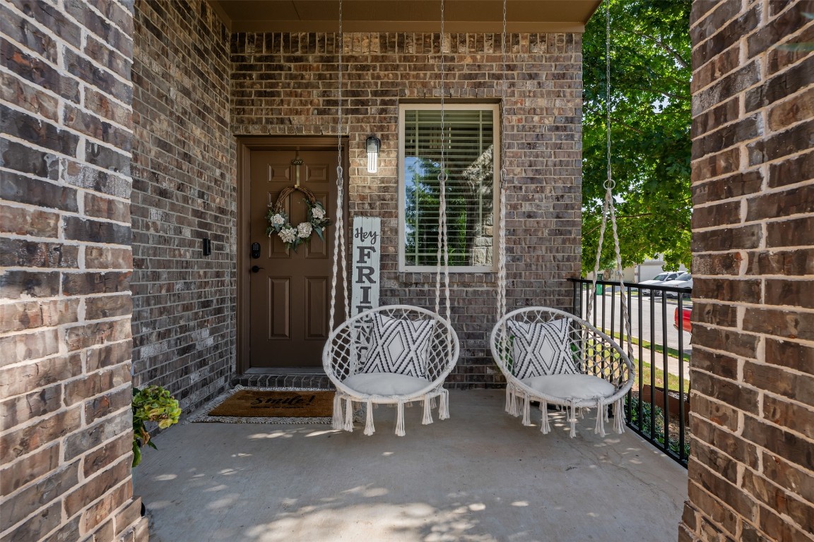 a view of a chair and table in the back yard of the house