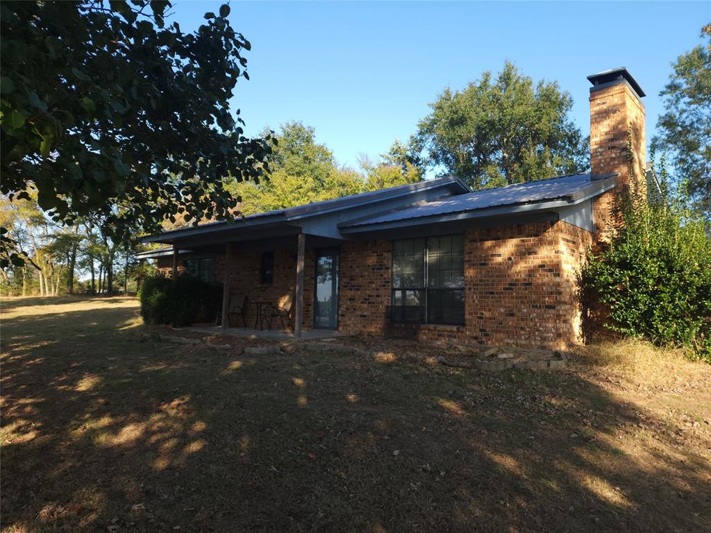 a front view of a house with a tree