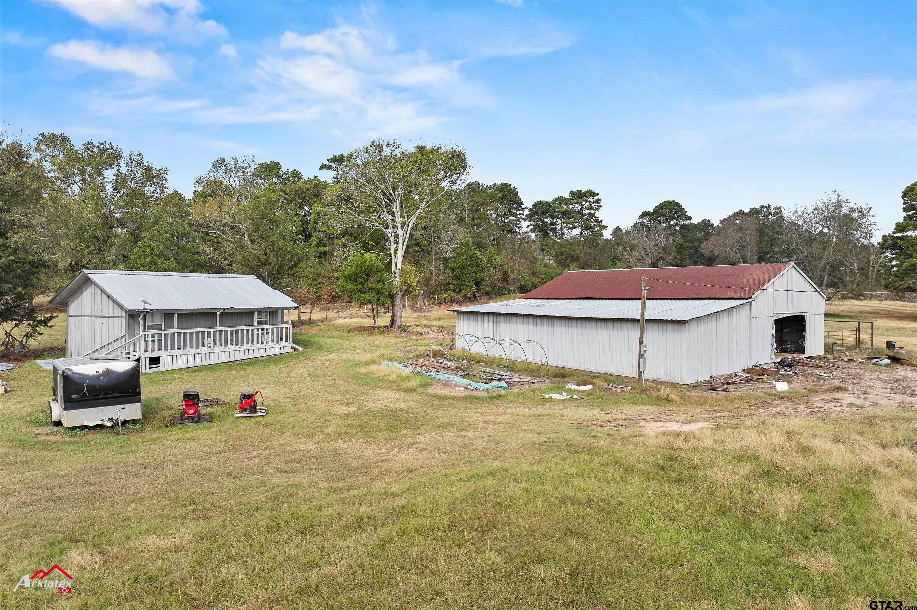 a view of a house with swimming pool and a yard