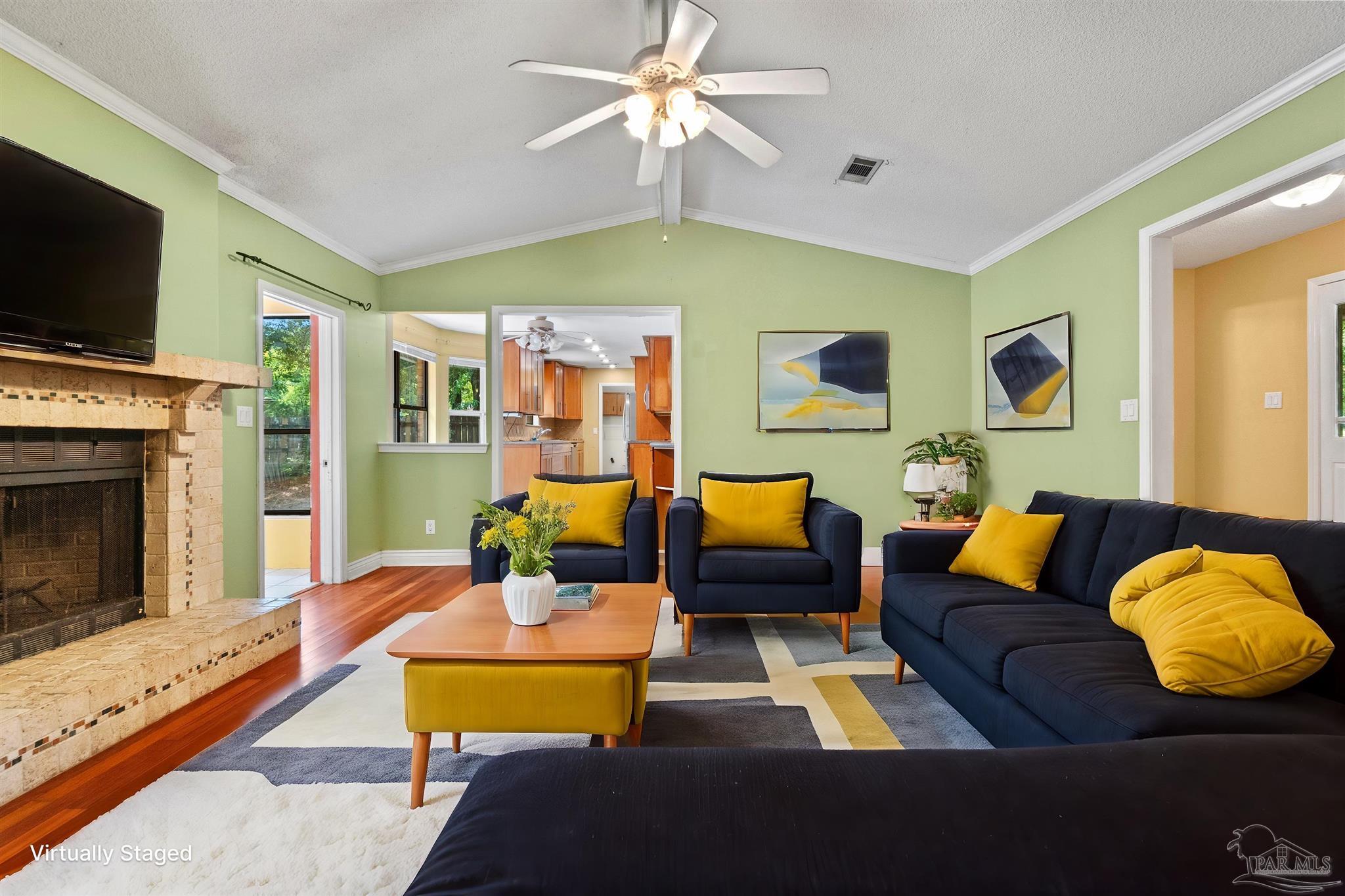 a living room with furniture fireplace and flat screen tv