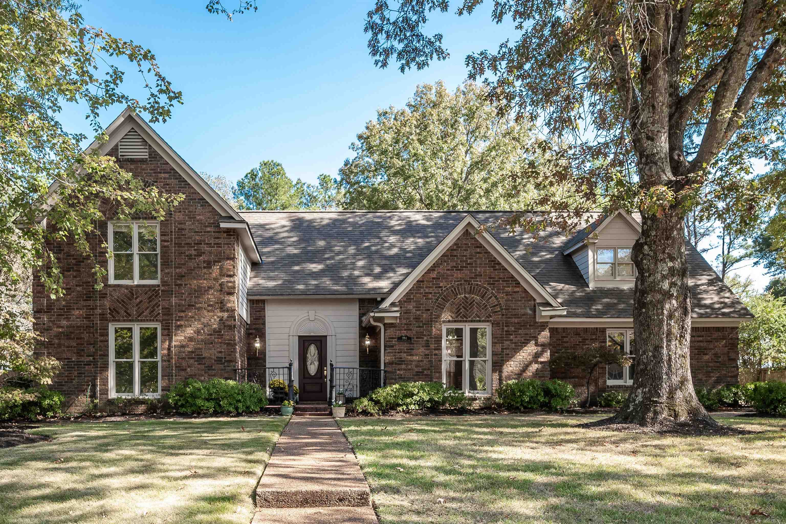 a front view of a house with a yard