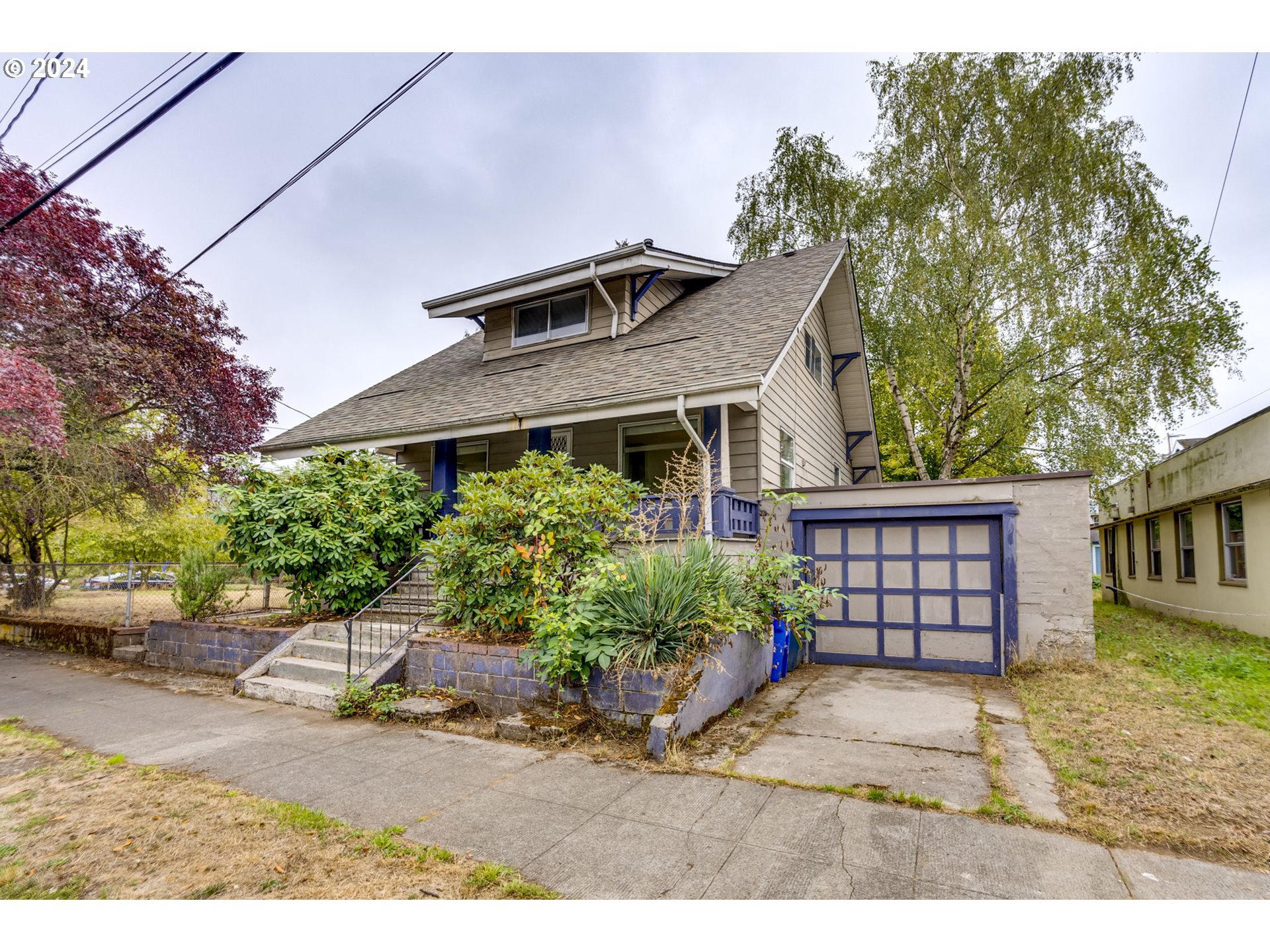 a front view of a house with a garden