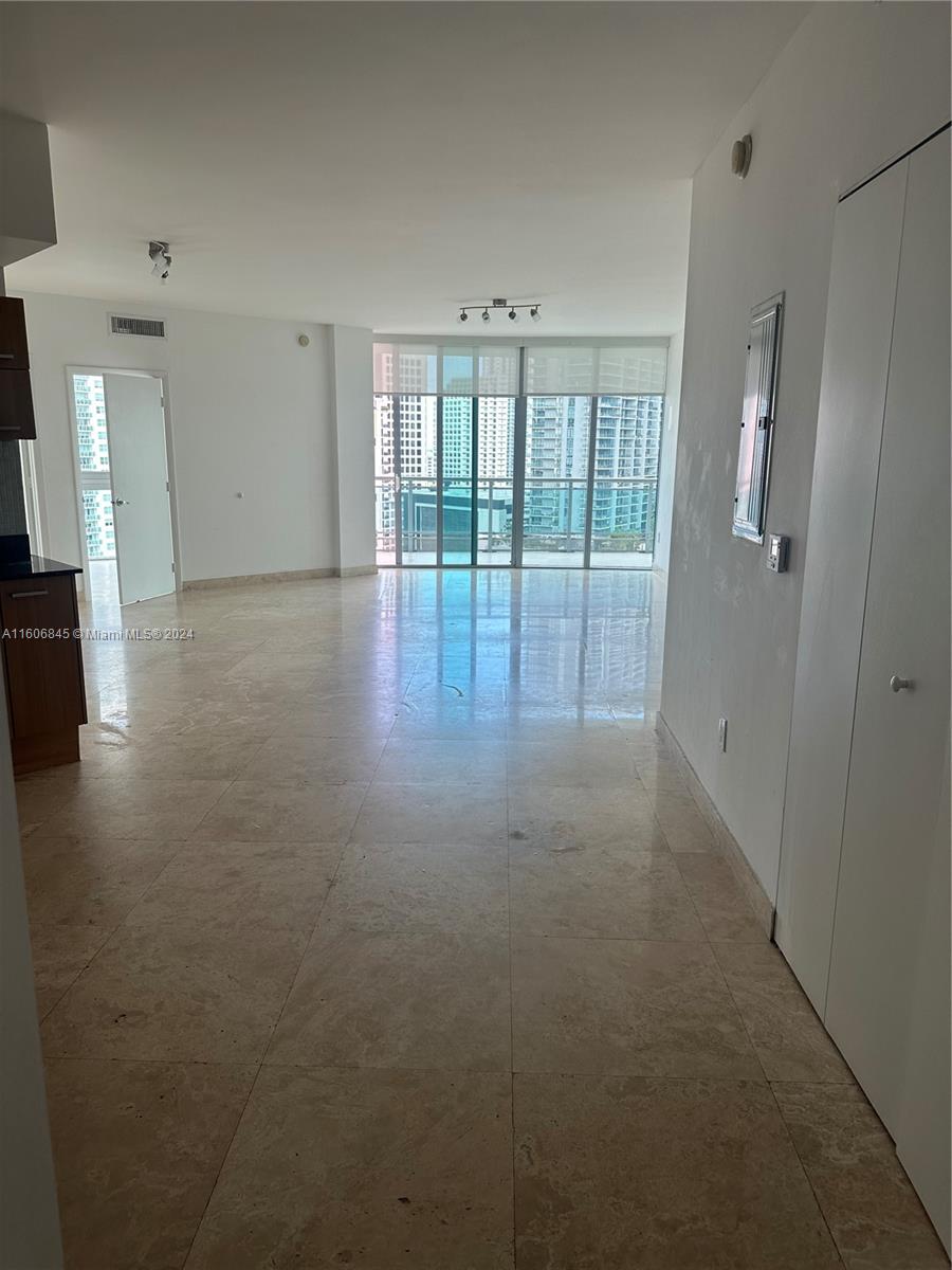 a view of empty room with floor to ceiling window