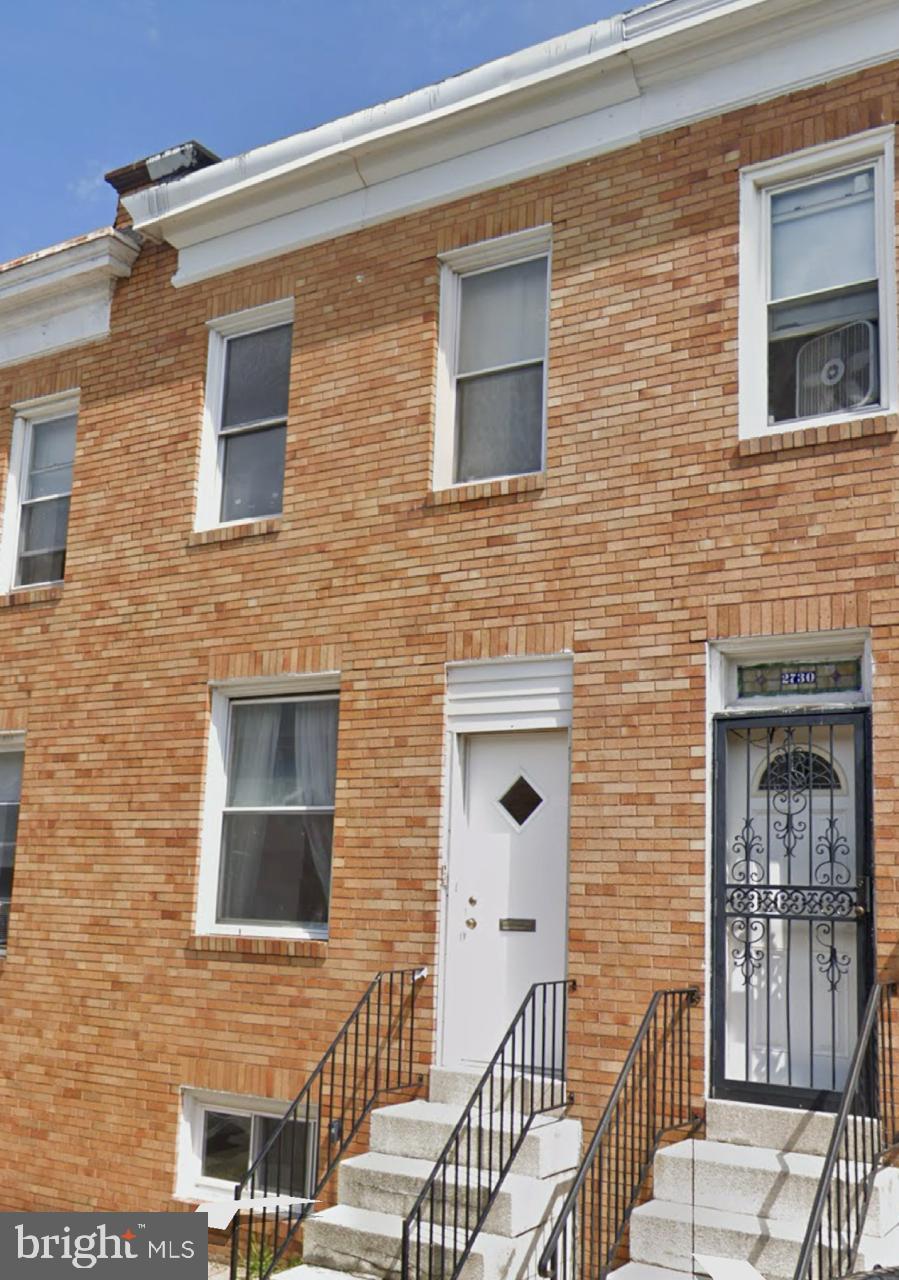 a brick house with four windows