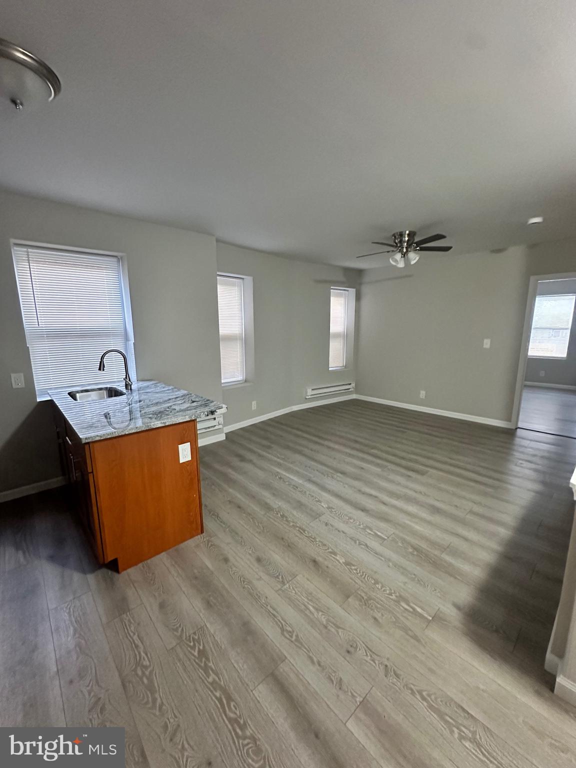 a view of a room with wooden floor