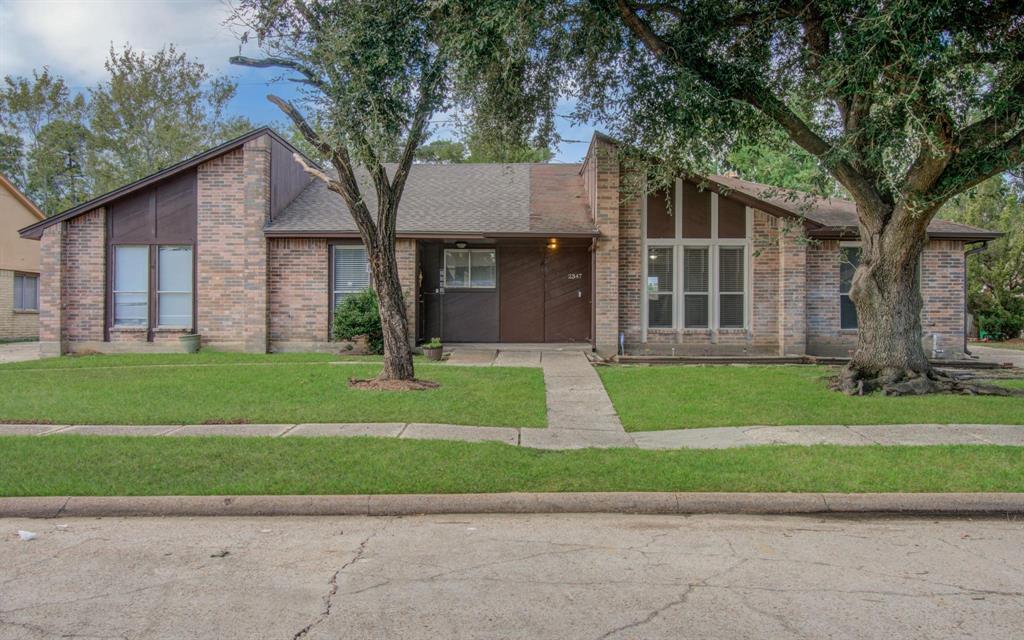 a front view of a house with a yard and a garage