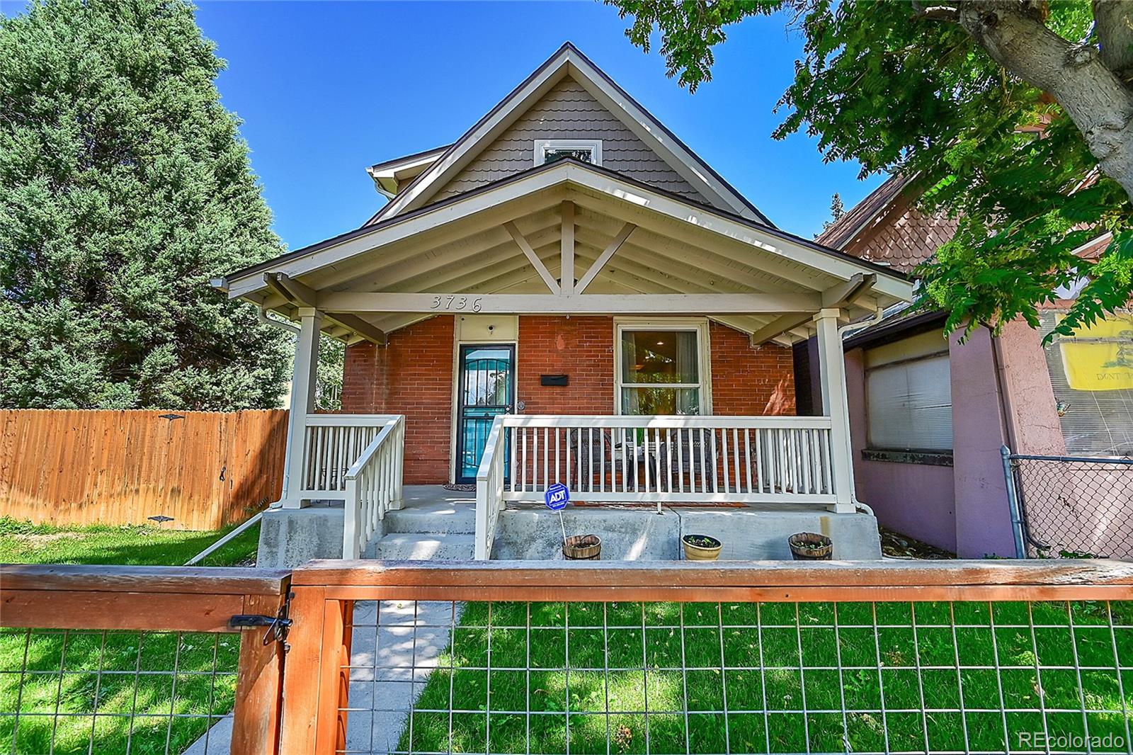 a view of a house with a yard balcony and furniture