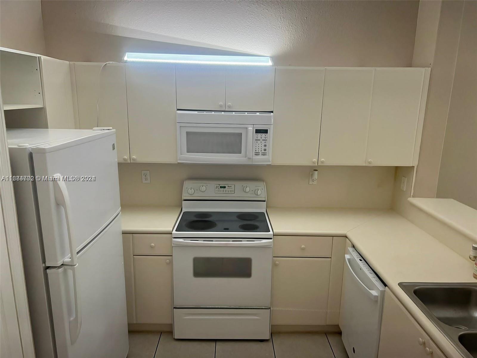 a kitchen with a stove and a refrigerator