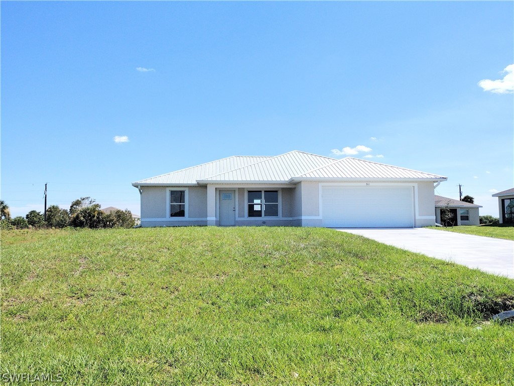 a front view of a house with a garden and yard