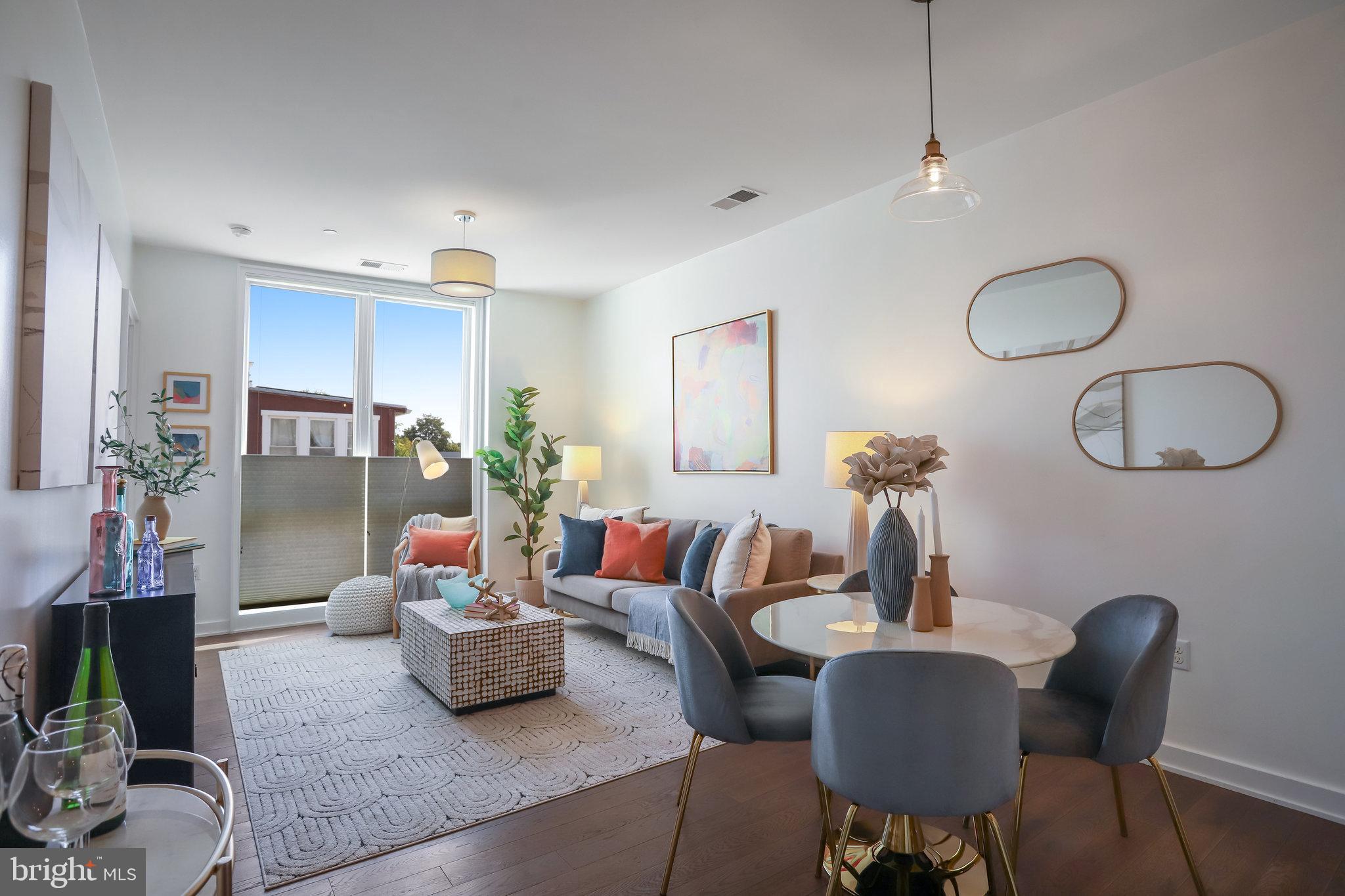 a living room with furniture potted plant and a mirror