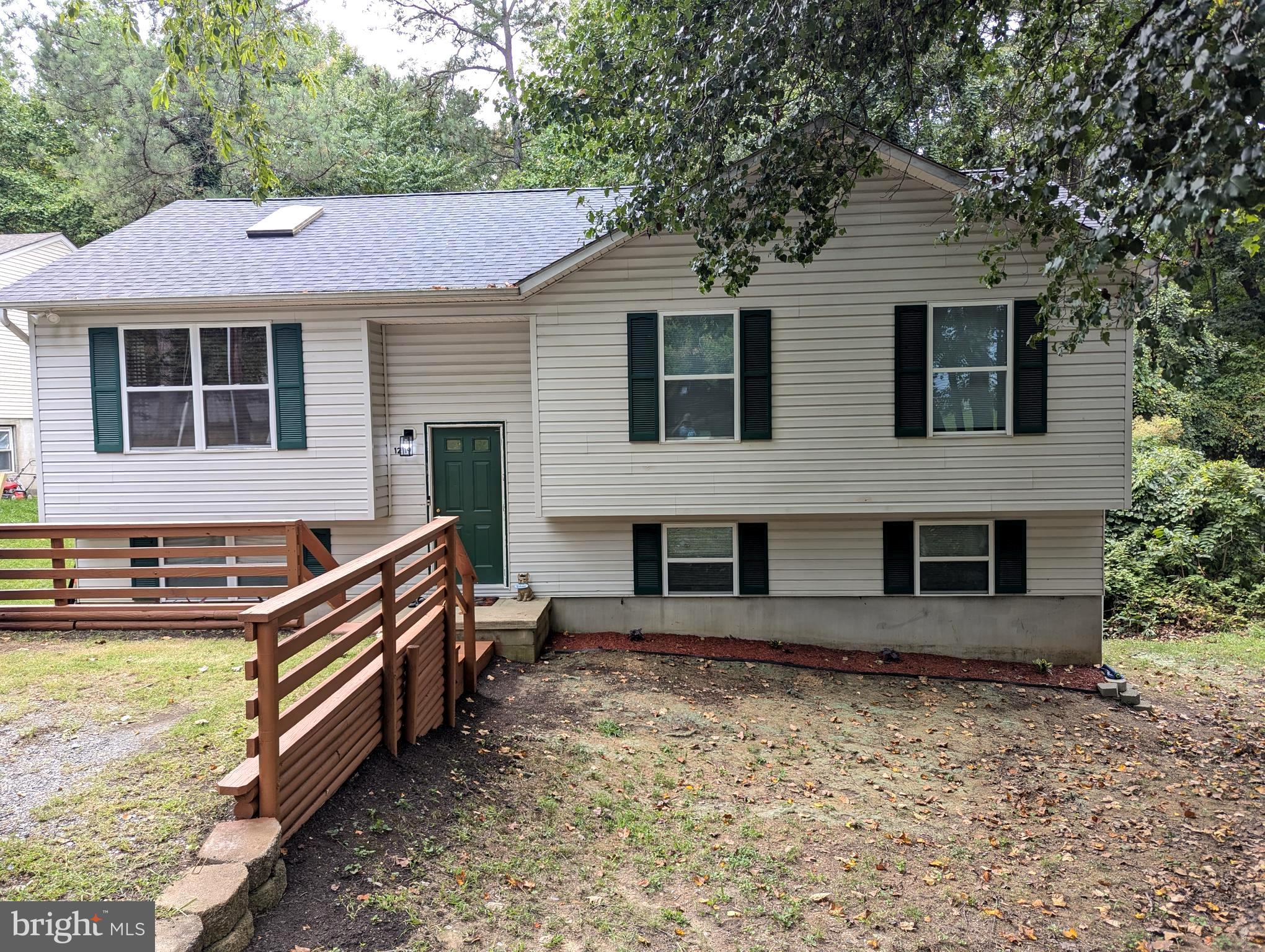 a front view of a house with yard and trees