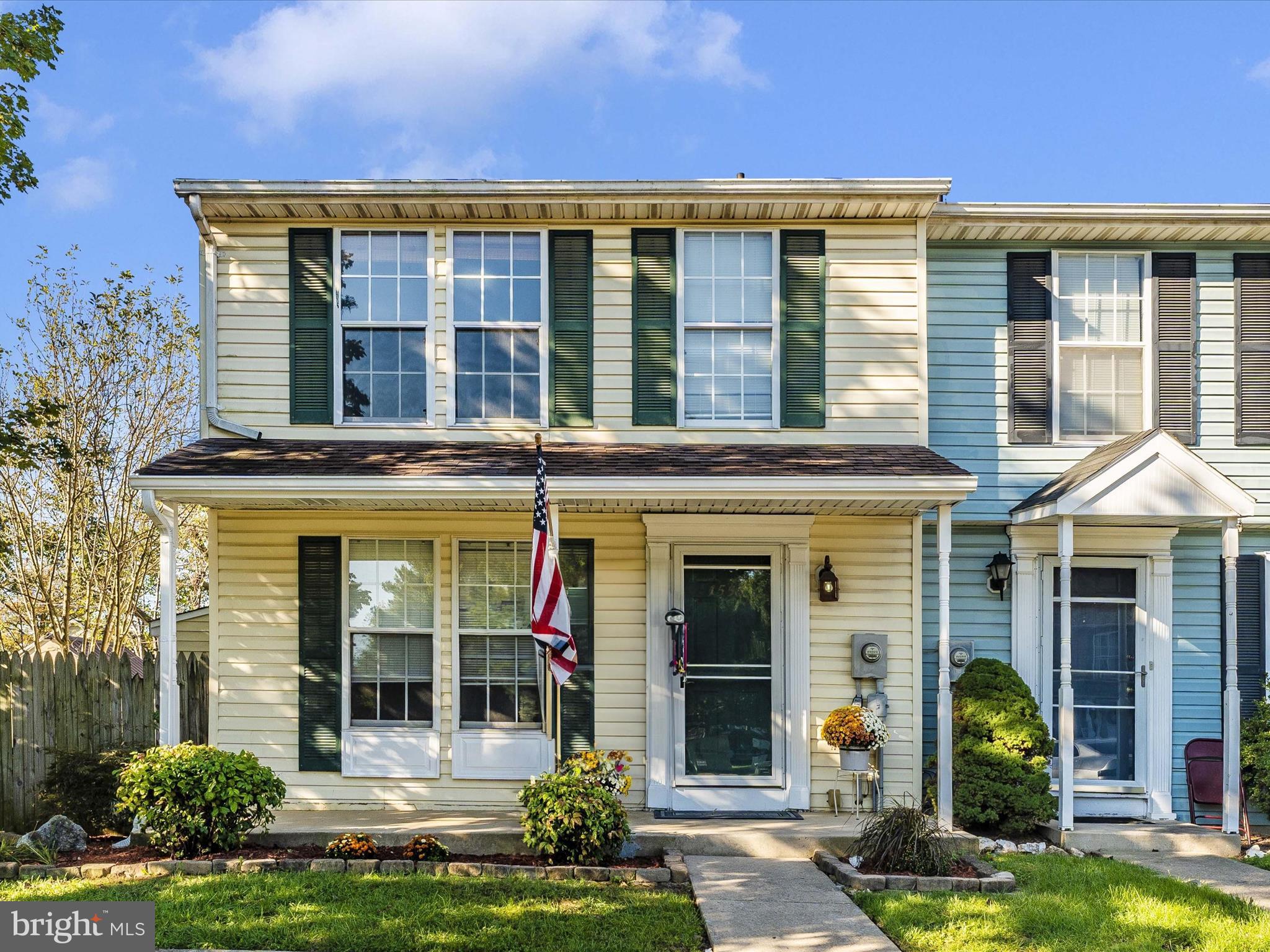 front view of a brick house with a yard