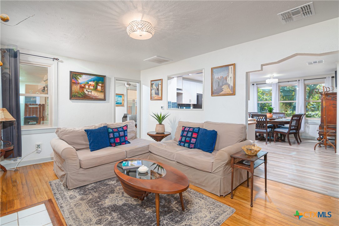 a living room with furniture a rug and a large window