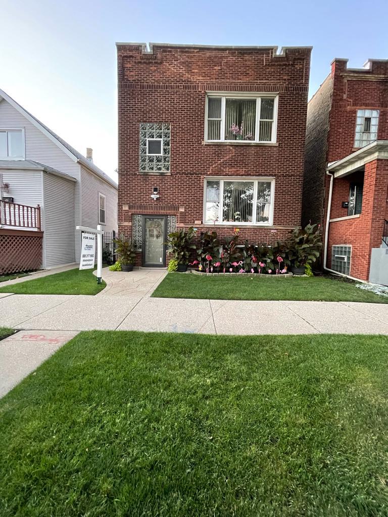 a front view of a house with a garden