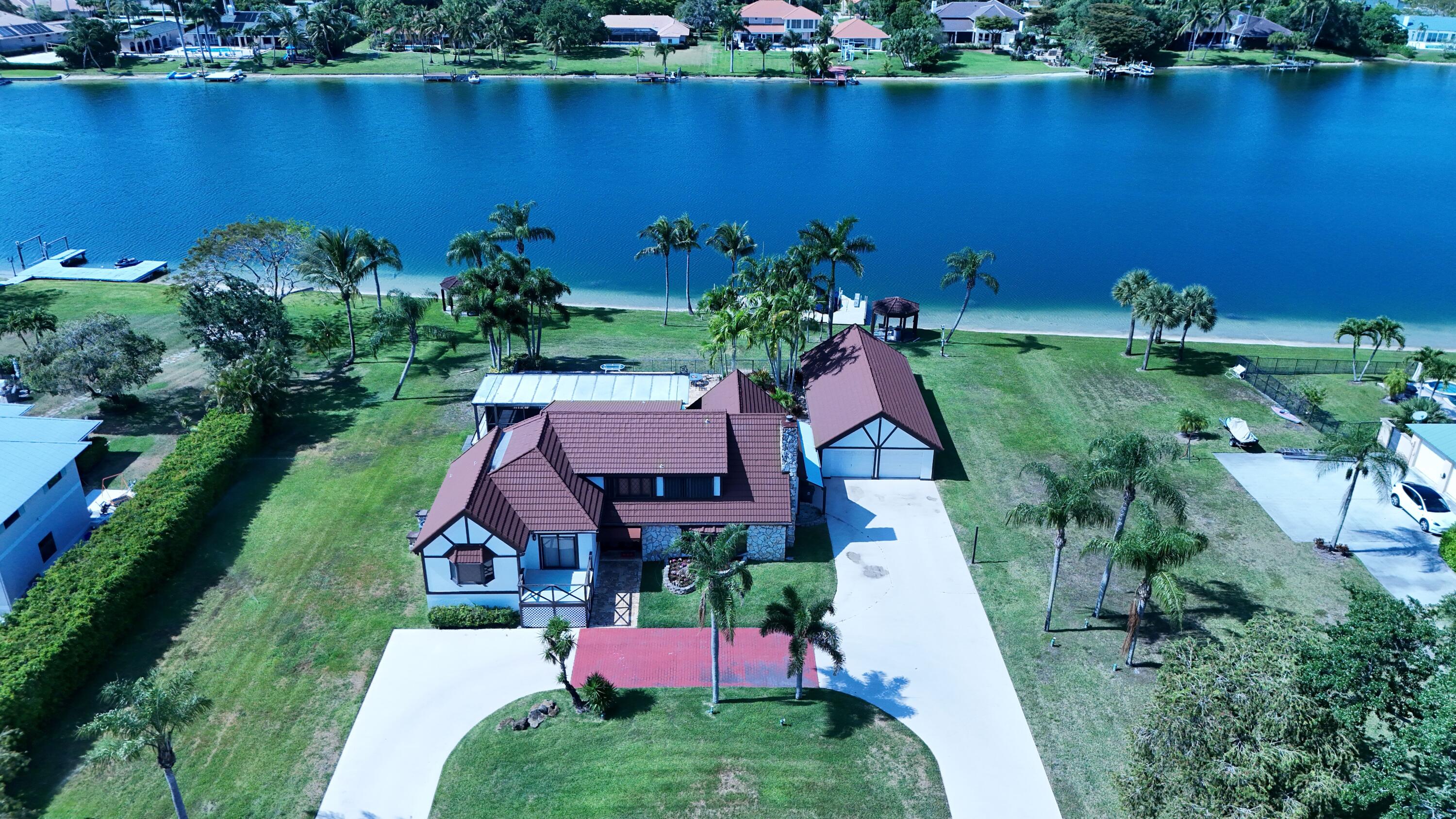 an aerial view of residential house with outdoor space and lake view