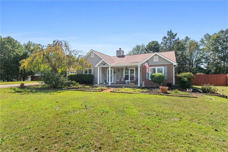 a front view of house with yard and swimming pool