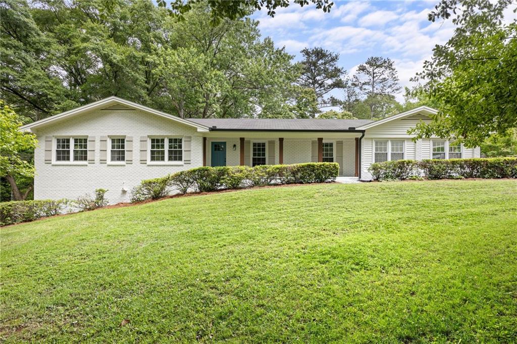 a front view of house with yard and green space