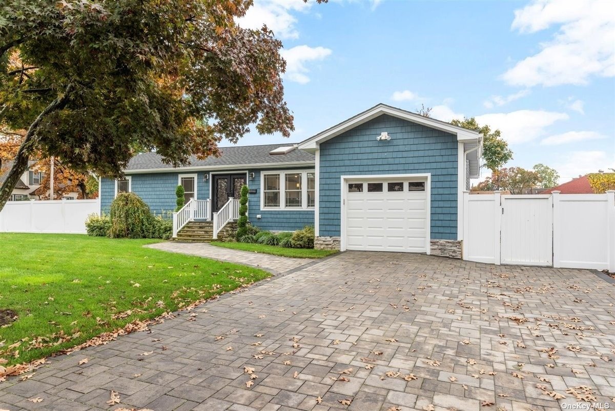 a front view of house with yard and green space