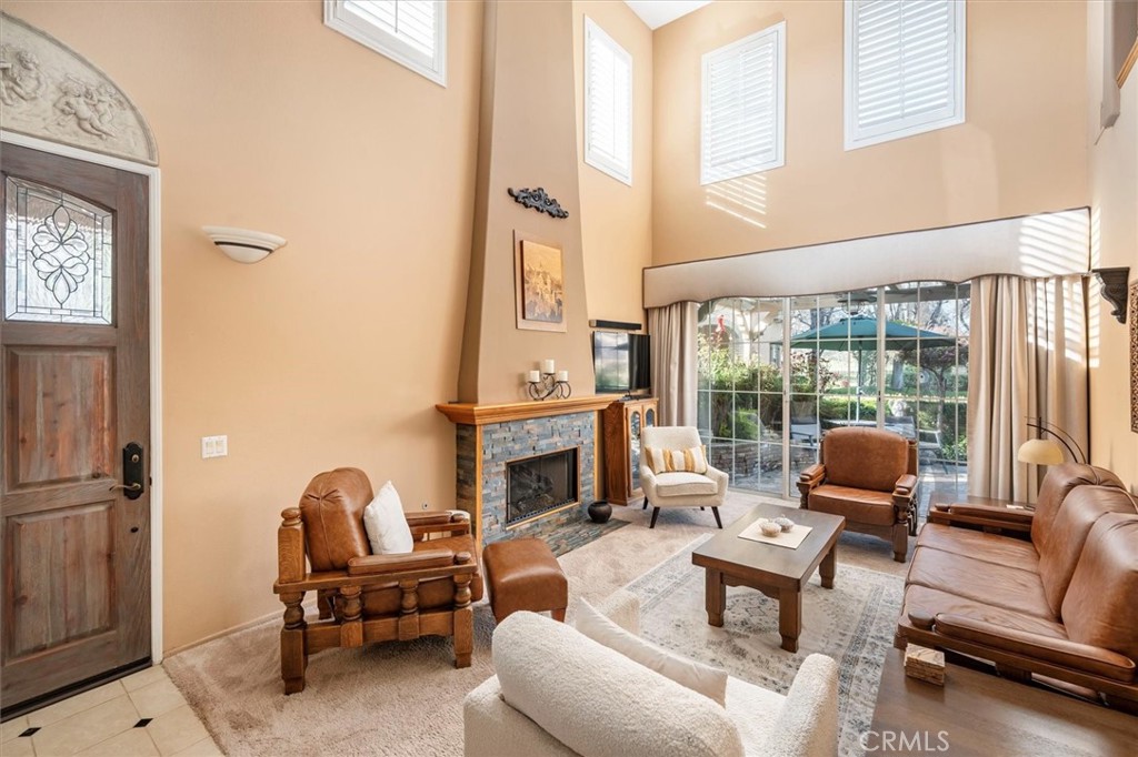 a living room with furniture fireplace and a floor to ceiling window