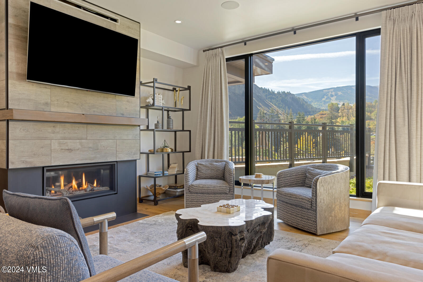 a living room with furniture a flat screen tv and a fireplace