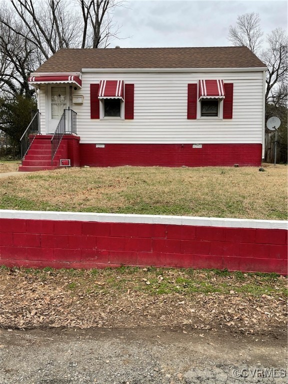 a view of a red and white house with a ground