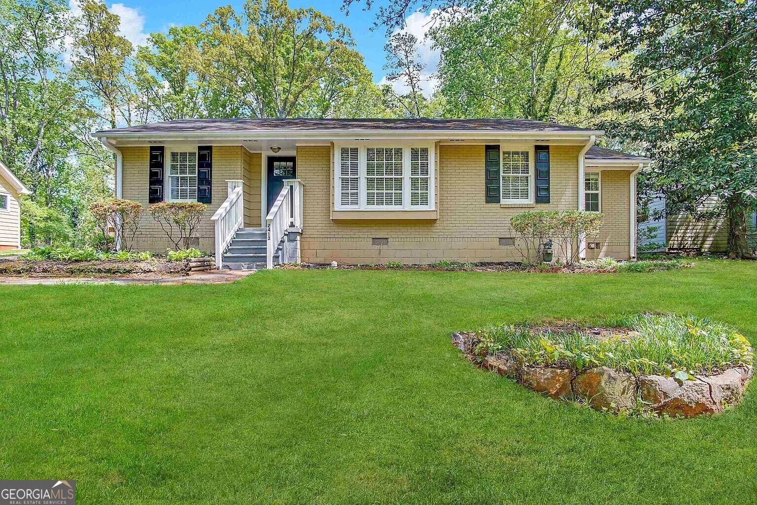 a front view of house with yard and green space