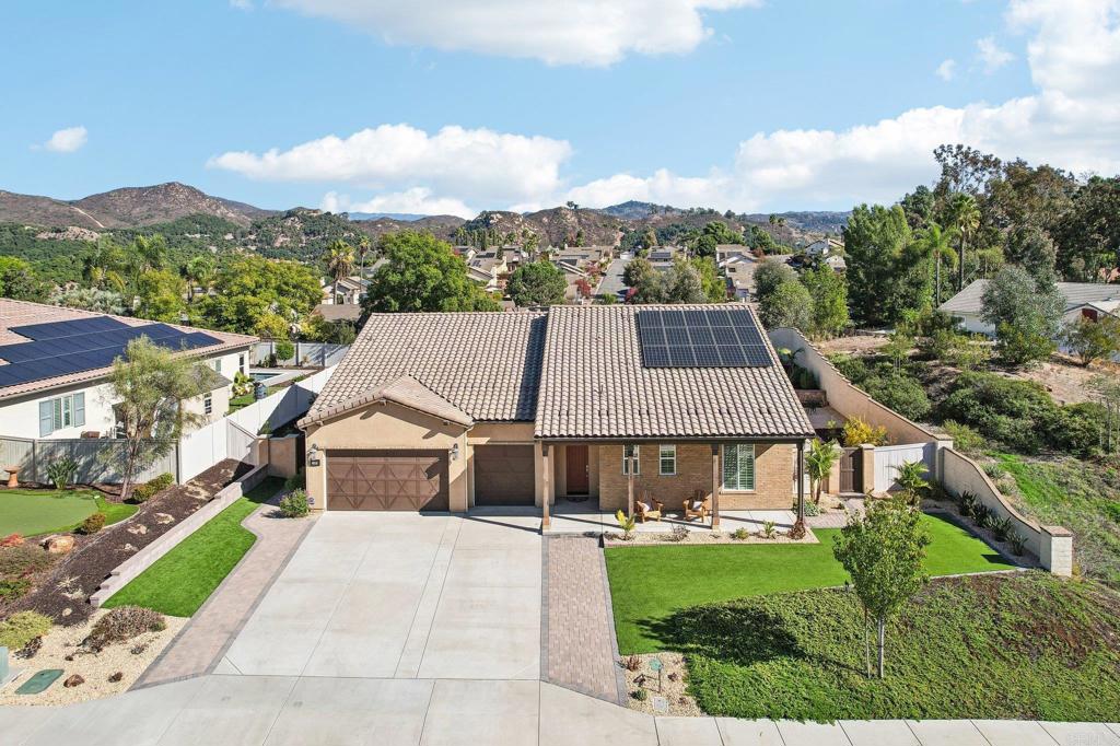 a aerial view of a house in middle of the green field