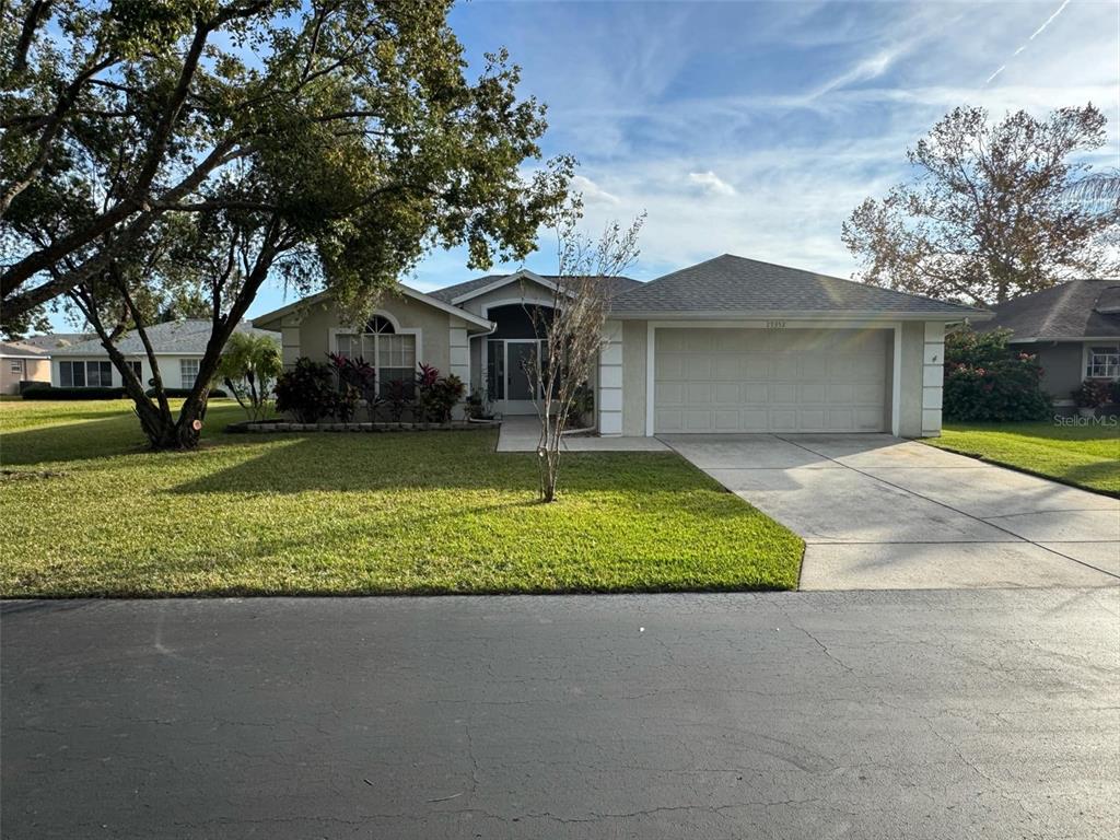 a front view of a house with a yard and garage