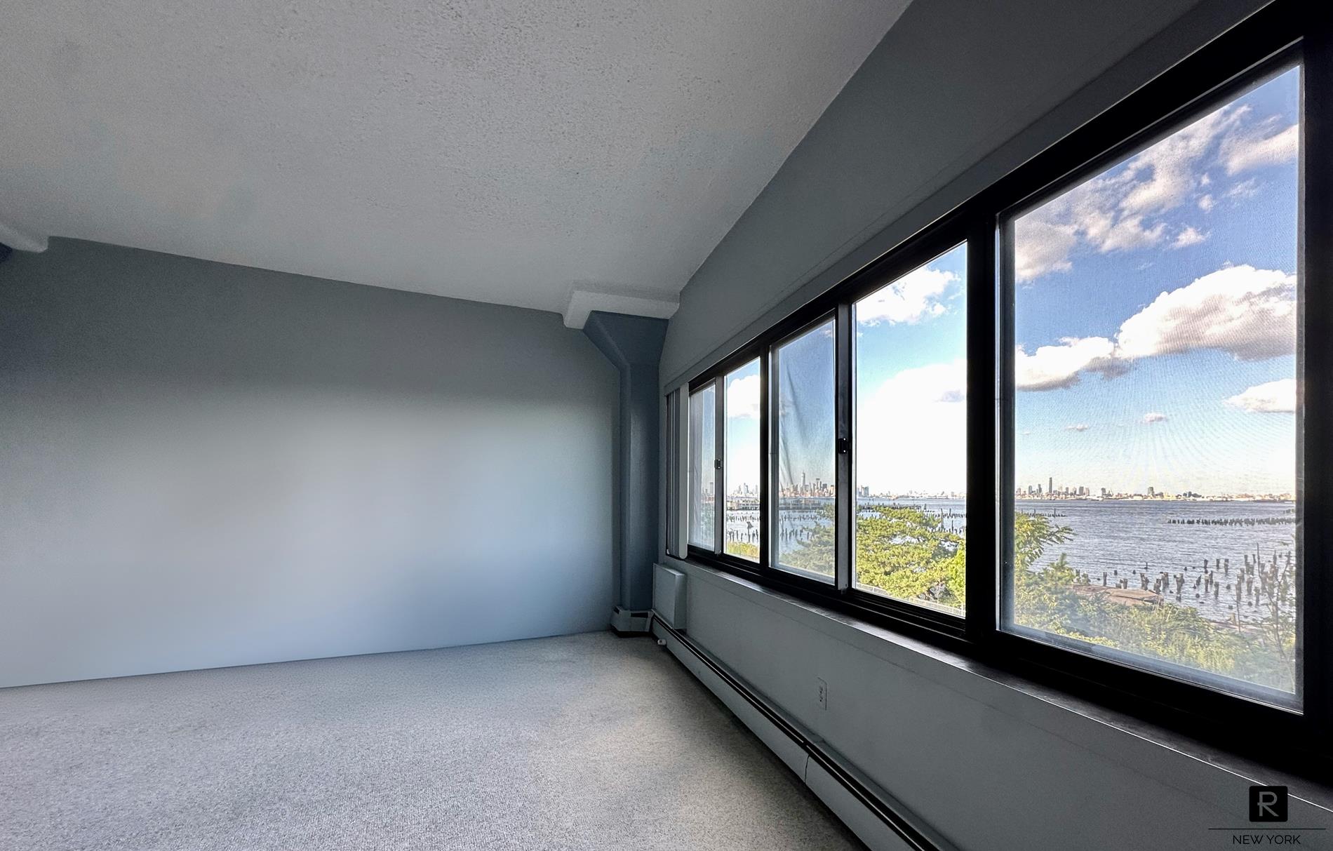 a view of an empty room with a large window