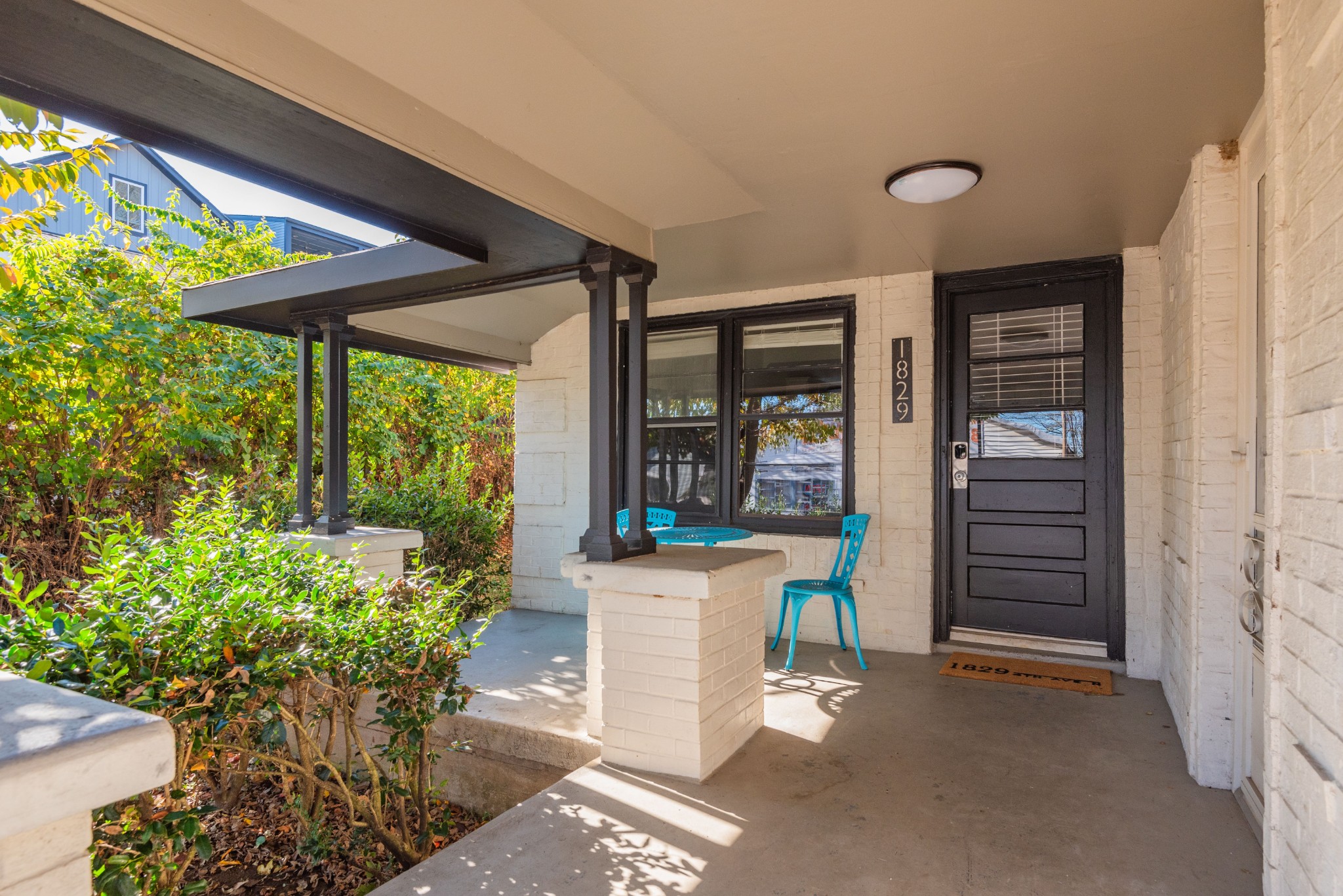 a view of a porch with furniture and garden