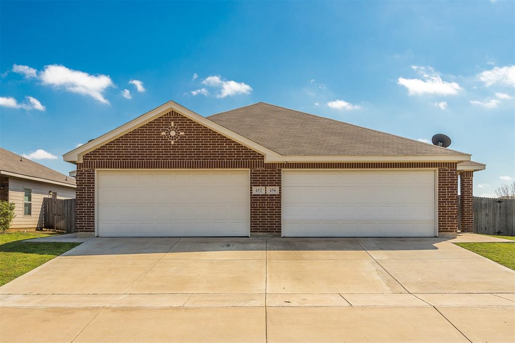 a front view of a house with garage