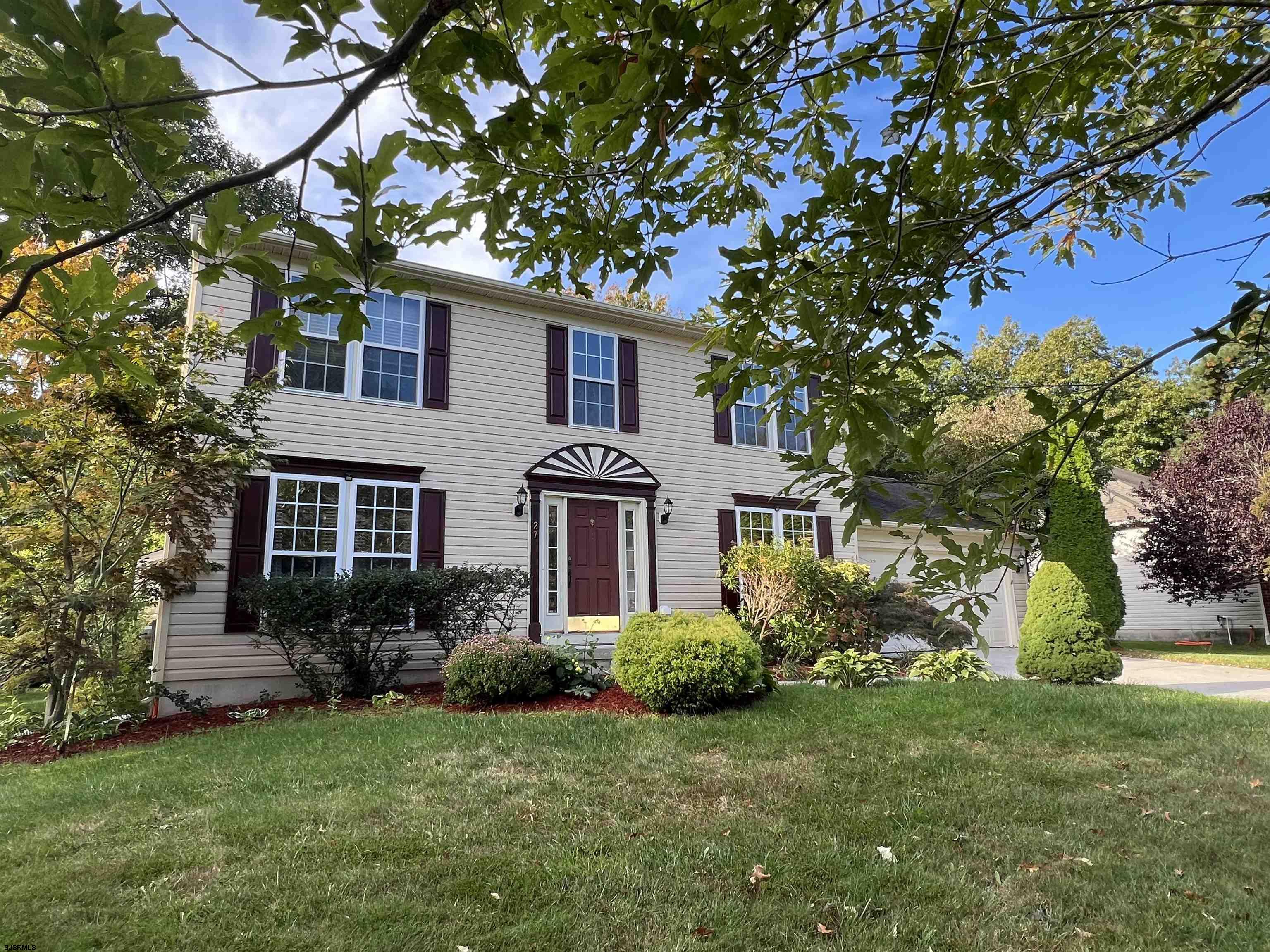 a house that has a tree in front of the house