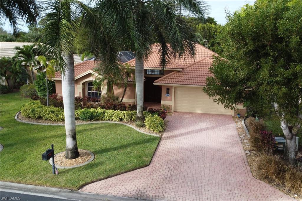 Mediterranean / spanish-style house with a garage and a front yard