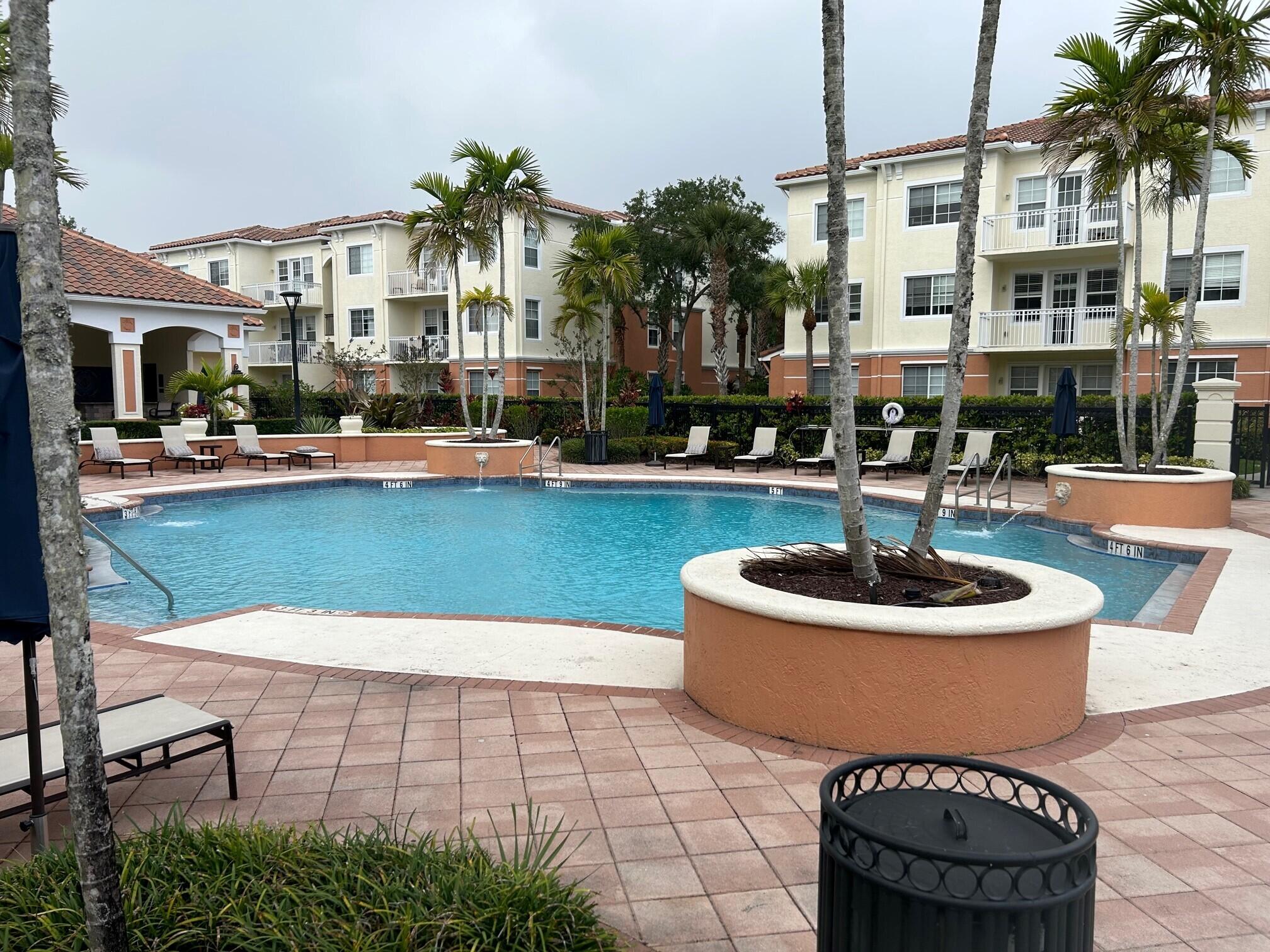 a view of a swimming pool with lounge chairs