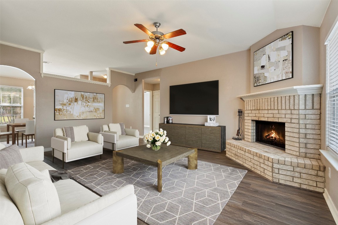 a living room with furniture a fireplace and a flat screen tv