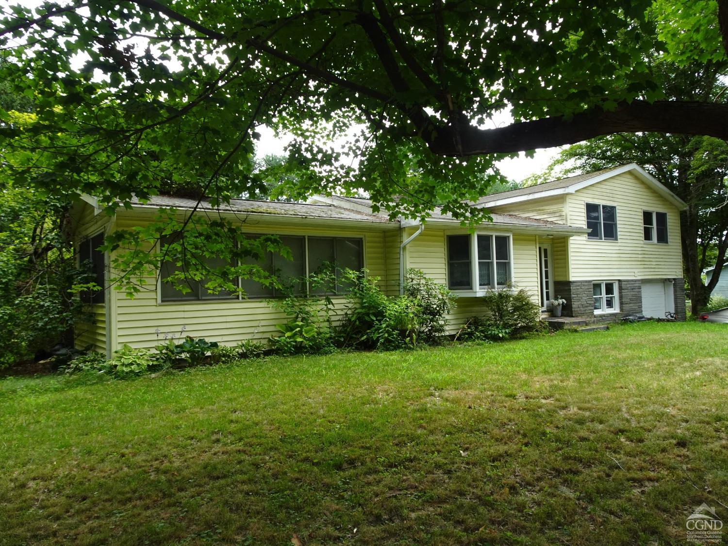 a front view of a house with a garden