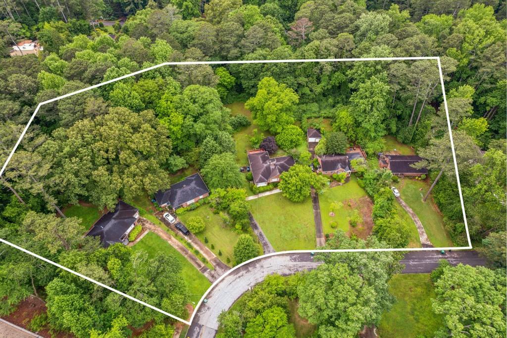 an aerial view of a residential houses with yard and outdoor seating