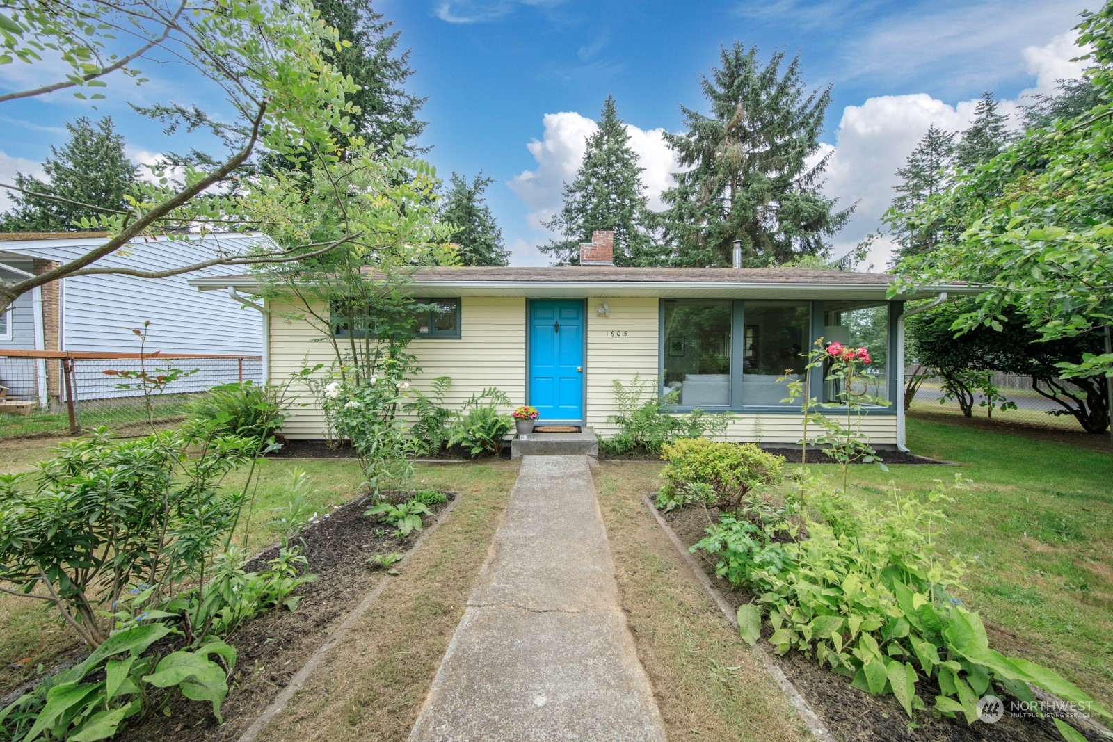 a front view of a house with garden